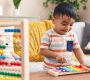 adorable hispanic toddler playing xylophone standing home_839833 29500 90x80